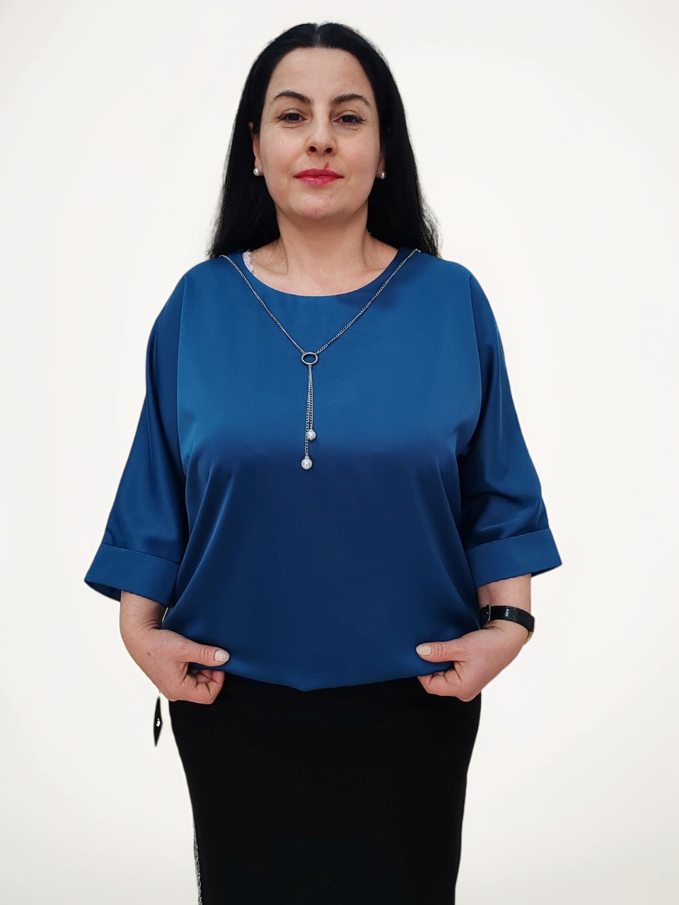 ბლუზა აღნთქვა ქალის მოდელი თეთრი ფონის წინ, იაპონური აბრეშუმის ქსოვილისგან დამზადებული ბლუზები ბიშკეკიდან.